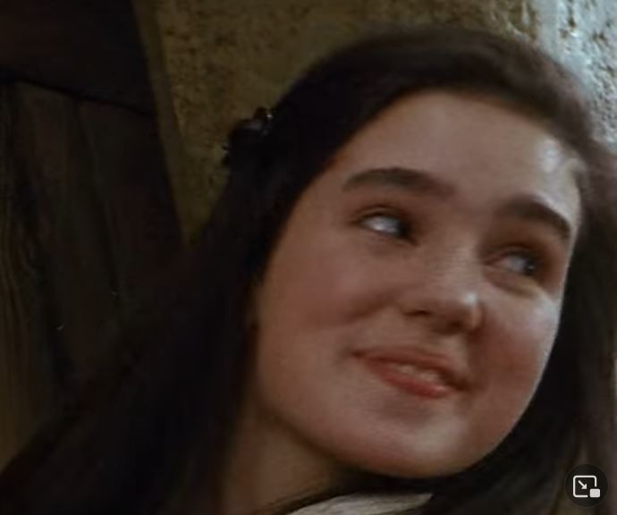 Close up picture of Sarah smiling  with teeth.