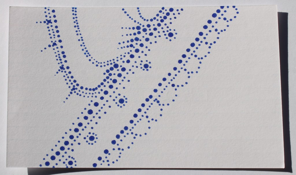 Abstract image made entirely of small blue dots. Shape suggested is of a line of lace with spiky forms curving upward in a few branches.
